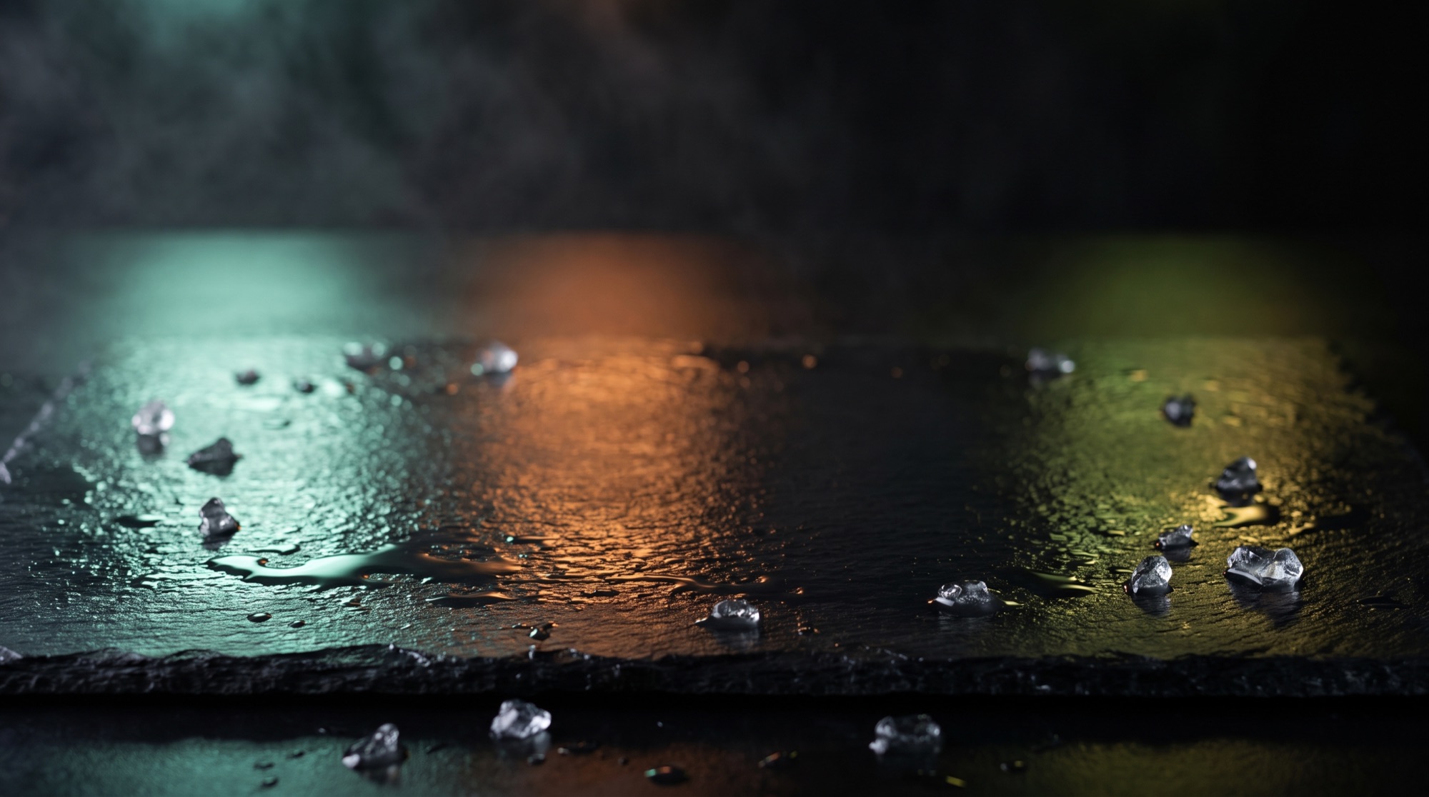 Wet black slate lit by teal, amber and gold light